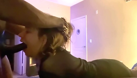 Brunette in red is sucking on a big cock on webcam