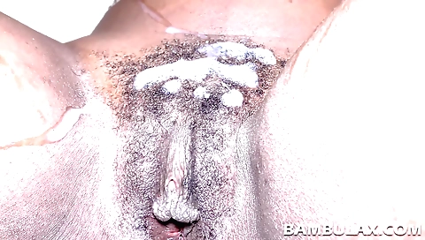 Ebony girl with a juicy pussy is getting cum on her hairy pussy